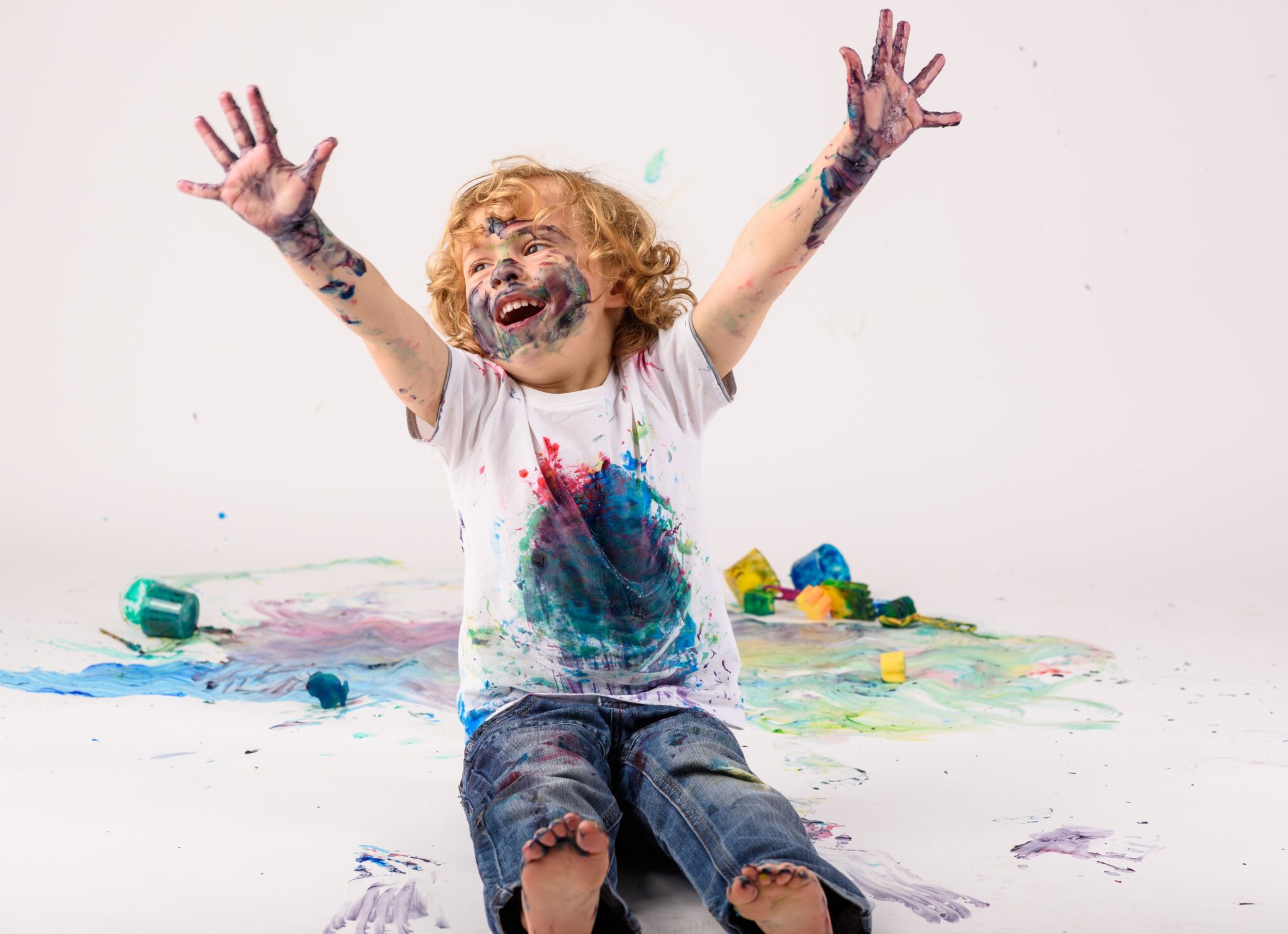 boy covered in paint smiling