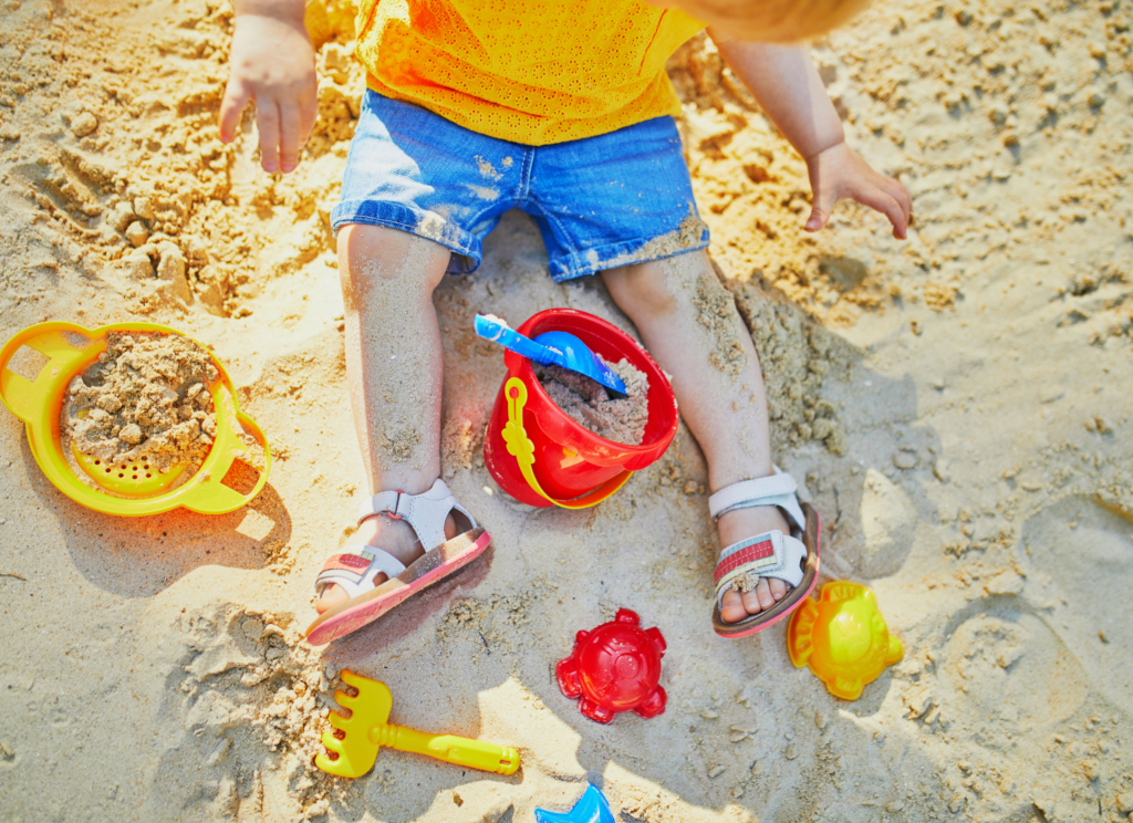 toddler playing in the sand