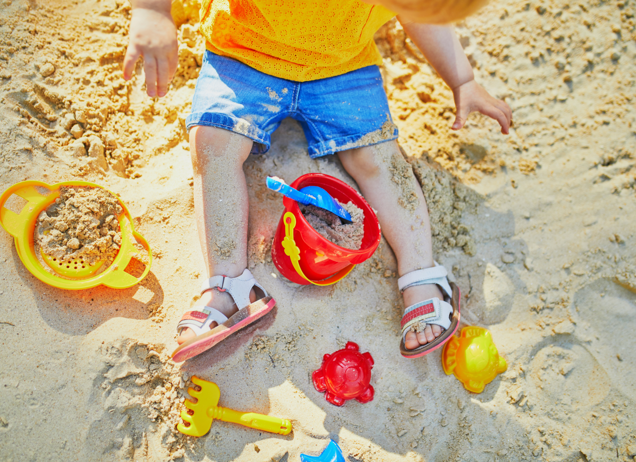 toddler playing in the sand